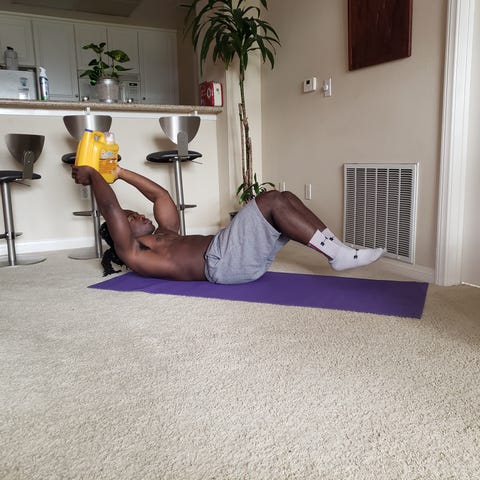 Osazee Edebiri works out in his home.