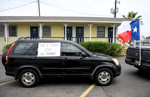 A "This is Texas Stop the Tyranny" sign is during during the driving protest, Tuesday, April 21, 2020, in Port Aransas. The protest opposes the mayoral declaration that prohibits certain kinds of business activity to prevent the spread of the coronavirus.
