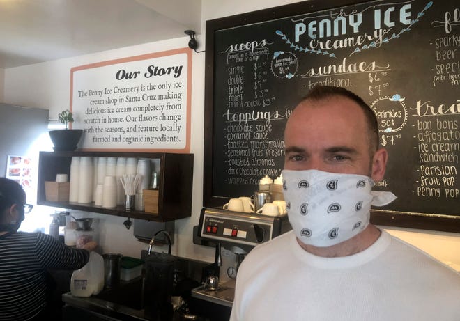 Zachary Davis poses for a photo at The Penny Ice Creamery in Santa Cruz, Calif. "We were feeling pretty good about where we were in the world. Now it’s just all turned upside down,” said Davis, who had to lay off 70 workers.