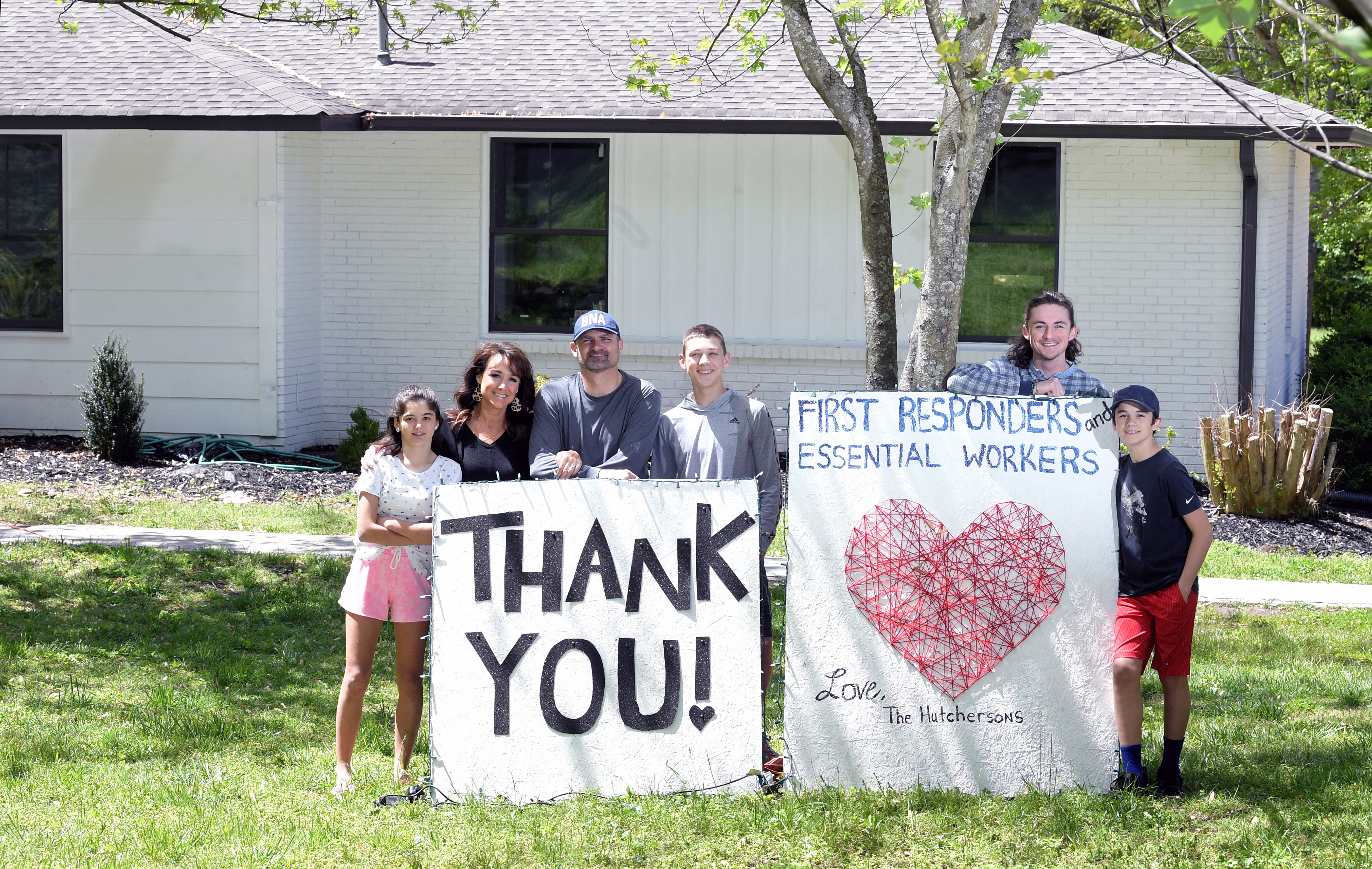 Brentwood resident Traci Hutcherson is a lifestyle blogger and mother of five children. The family created homemade thank-you signs for essential workers that they placed in their front yard. Standing with signs are Hutcherson and her husband, Cy, and four of their children, Sania, Adam, Luke and Eli.