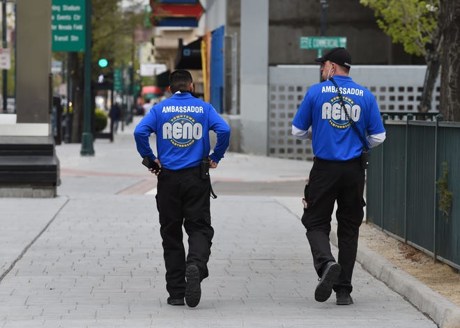 Reno ambassadors walk up Virginia Street in downtown Reno, Nevada amid the COVID-19 pandemic on Monday April 20, 2020.