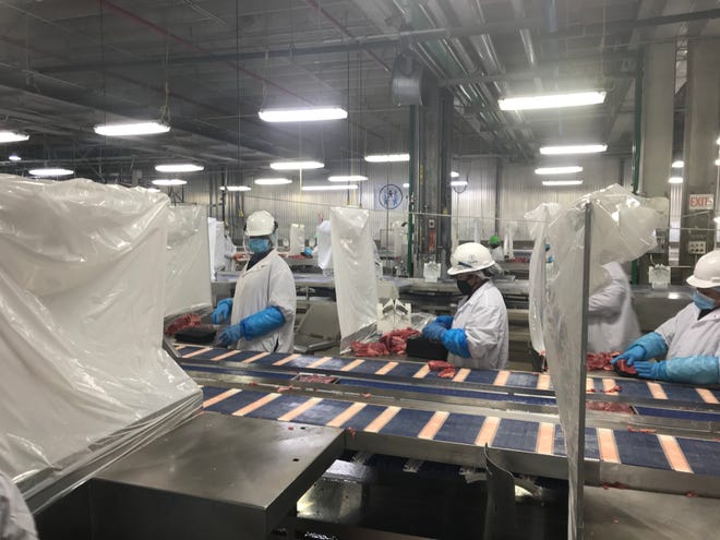 Tyson Foods installed plastic barriers between worker stations at its meat and poultry plants to protect against transmission of the coronavirus.
