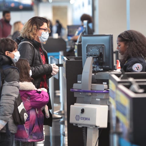Passenger go through TSA screening at a nearly-des