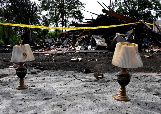 Lamps are set aside after being salvaged from an overnight fire in the 1600 block of Chestnut Street Wednesday.