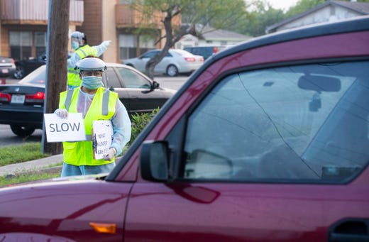Heath care workers conduct COVID-19 testing at the Corpus Christi's drive-thru testing center at the old Christus Spohn Memorial Hospital parking lot on Thursday, April 23, 2020.