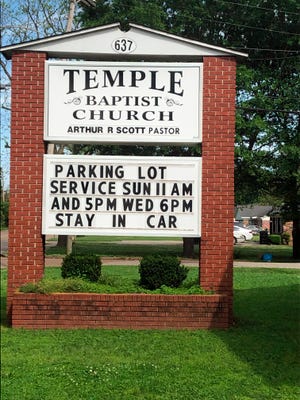 This image provided by Alliance Defending Freedom shows the sign for parking lot church services outside of Temple Baptist Church in Greenville, Miss., on April 9, 2020. The Justice Department has weighed in on a local Mississippi case involving a church that says its religious freedoms were violated. Temple Baptist in Greenville has been holding drive-in services for congregants during the coronavirus outbreak.  (Alliance Defending Freedom via AP)