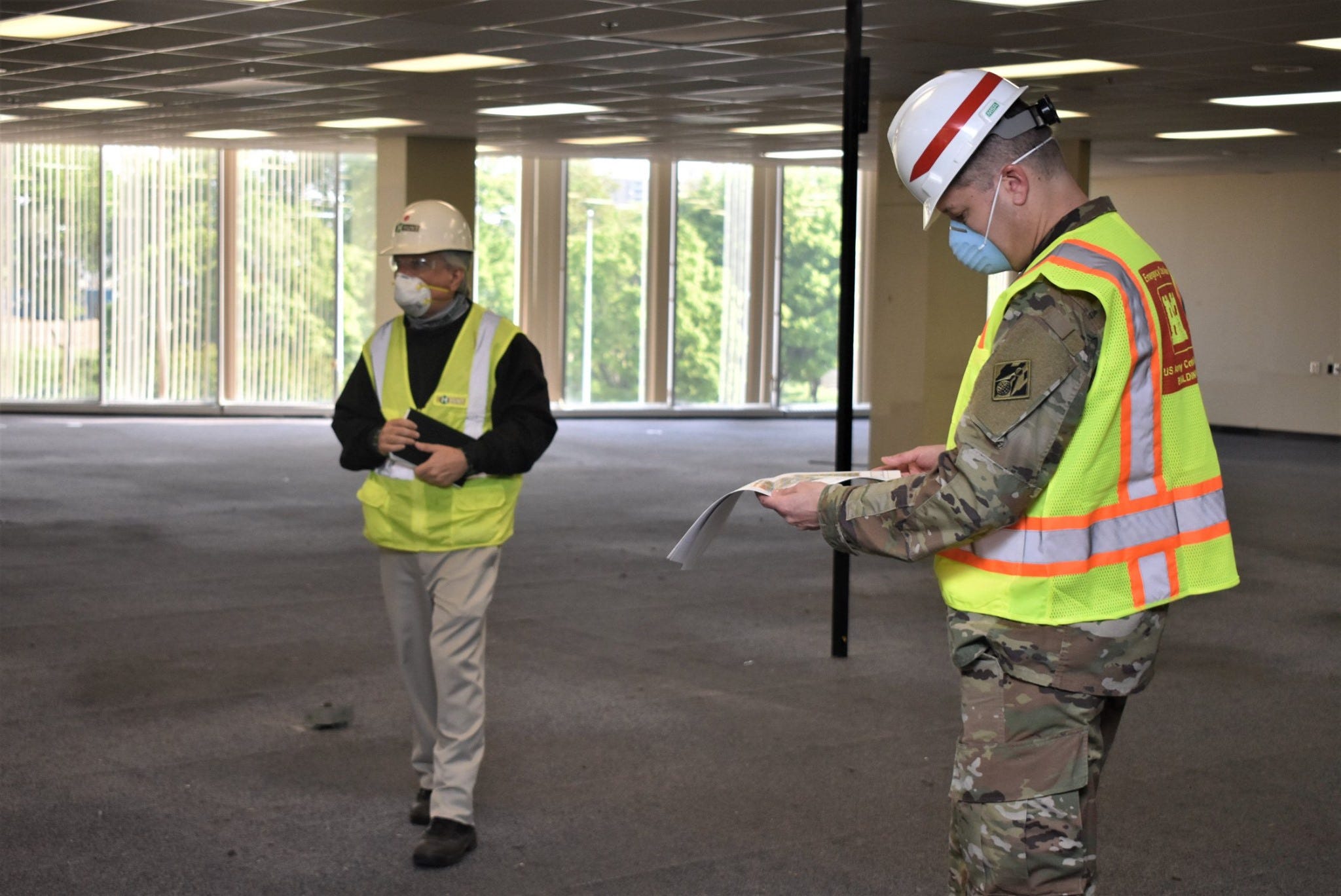 A U.S. Army Corps of Engineers worker reviews plans for the third floor of the former Commercial Appeal building in Memphis, which is being renovated as an Alternate Care Facility to treat COVID-19 patients. The Army issued a $51.4 million contract to AECOM for the project in April.