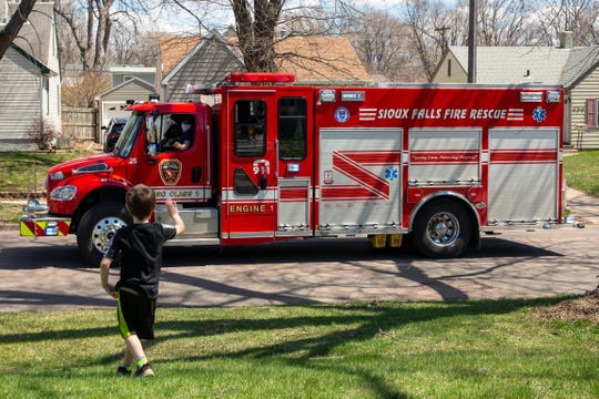 David Jurgens, 6, waves at a Sioux Falls Fire Rescue truck as it drives by for his birthday on Wednesday, April 22, 2020.