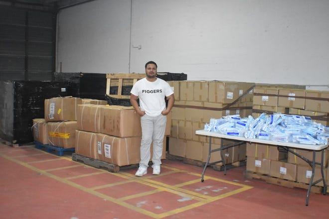 The Figgers Foundation donated more than 700,000 units of personal protective equipment to healthcare facilities in hotspots around the country. In the picture, Figgers Communications CEO Freddie Figgers stands near donations.
