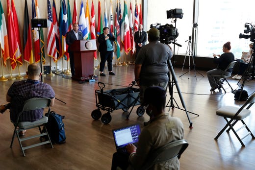 Members of the media observe social distancing as Dallas Mayor Eric Johnson, at podium, responds to a question during a news conference at City Hall where he discussed the latest developments amid the COVID-19 outbreak, in Dallas on Wednesday, April 22, 2020.