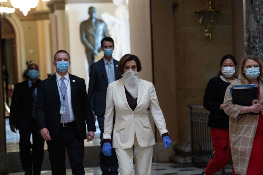 House Speaker Nancy Pelosi walks out of the chamber of the House of Representatives after the debate on the additional $484 billion dollar relief package amid the coronavirus pandemic.