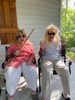 Twisted Sisters Shirley "Nenie" Mozingo, left, and Lucille "Grandma Cille" Barraza dress up for one of their TikTok videos that have gone viral since they made their debut this year. The sisters are pictured outside Mozingo's Hattiesburg home, where the videos are shot, usually in one take.