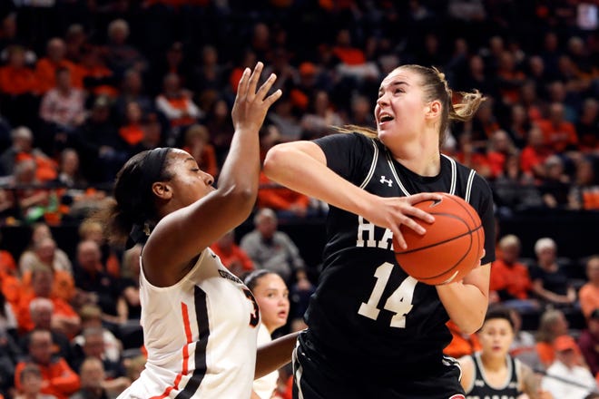 Hawaii's Lauren Rewers (14) tries to get past Oregon State's Madison Washington (3) during the first half of a game in December. Rewers is the newest addition to the Michigan State women's basketball program.