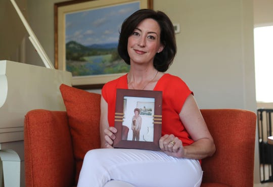 Katie Finn holds a picture of her grandmother Carole Gowdy in her La Quinta home, April 24, 2020. 