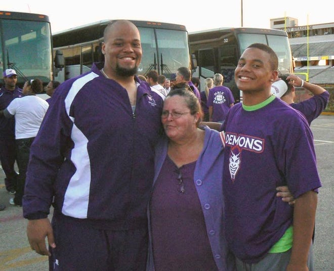 Jace Prescott (left) and Dak Prescott (right) pose with relative Pam Ebarb after a Northwestern State football game.
