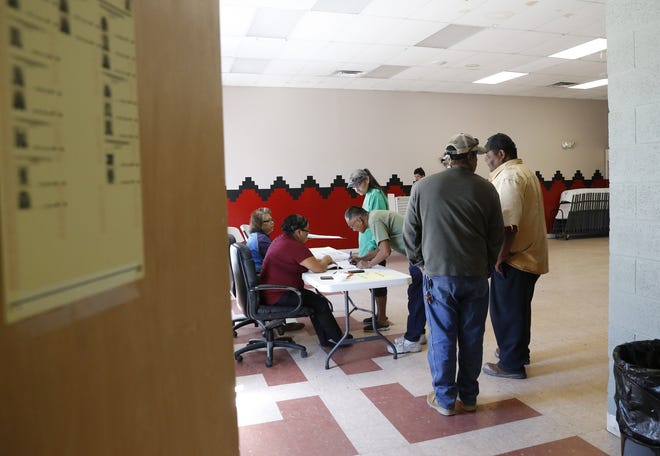 Voters form a line to receive ballots during the Navajo Nation primary election on Aug. 30, 2016 at the Tsé Daa K'aan Chapter house in Hogback.