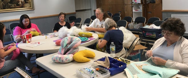 Members of The Church of Jesus Christ of Latter-day Saints, from left, Brittany Dransfield, Megan Copelin, Ann Nicholson, Trudie Bell, Maryalice Baumann and Diane Remsen, work on community service projects.
