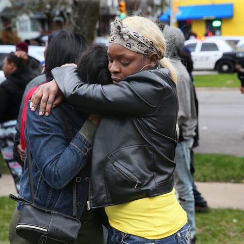 Bystanders comfort each other in Milwaukee in the 
