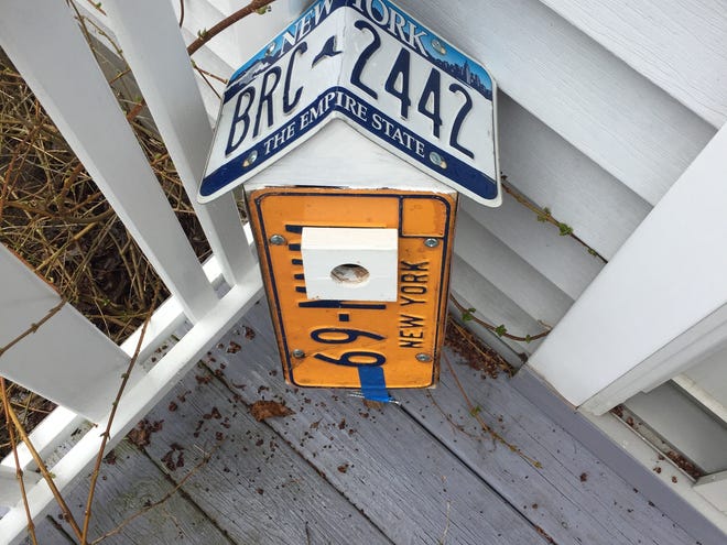 A birdhouse showed up on the porch, unannounced.