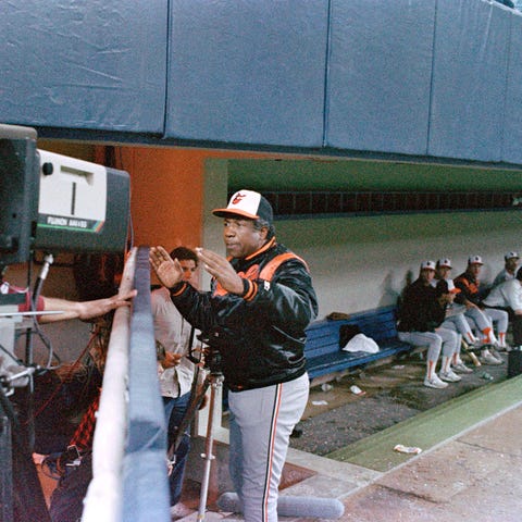 Baltimore Orioles manager Frank Robinson gives a w