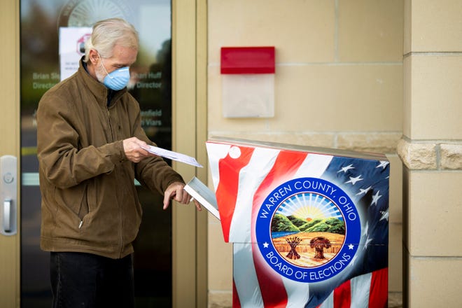 A voter turns in his ballot to the dropbox in front of Warren County Board of Elections in Lebanon, Ohio on Tuesday, April 28, 2020. 