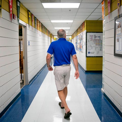 Principal Jon Bremseth walks through an empty hall