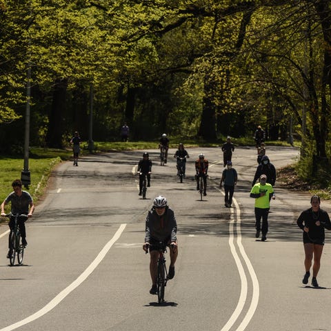 People jog and ride bicycles in Prospect Park on A