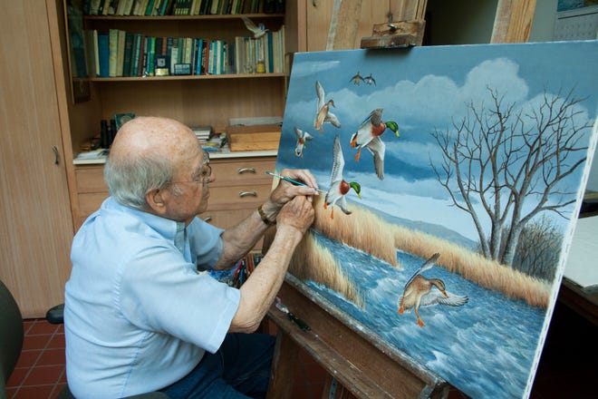 Noted artist Maynard Reece of Des Moines at work at the easel