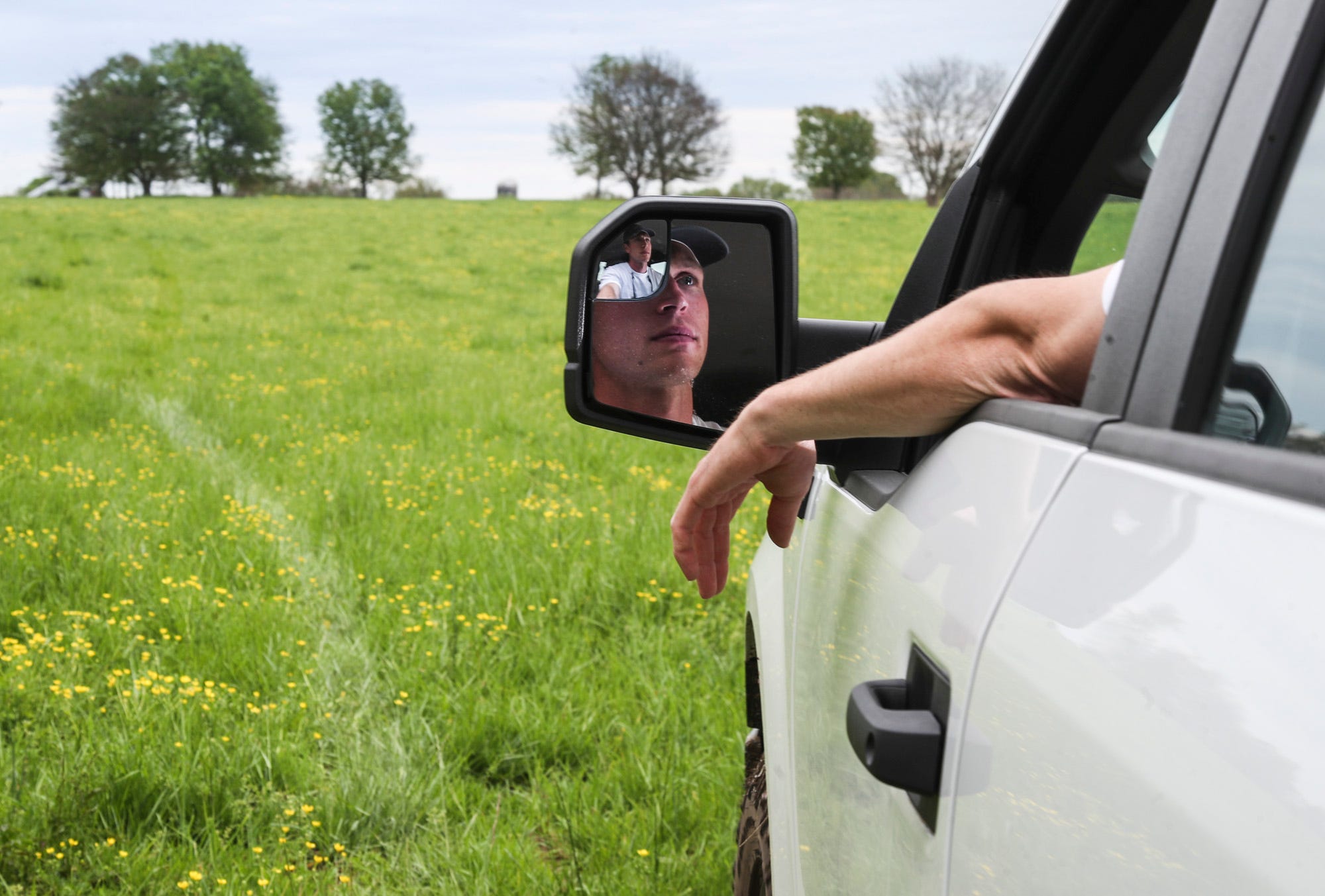 Driving out to one of his fields, Joe Lowe, 29, is a cattle rancher for his family's Oak Hollow Angus in Smiths Grove, Ky. The Lowes raise angus cattle on more than 1,000 acres. "People have to eat," Lowe said. "We've got the capability to feed everyone. There's plenty of food out there, it's just logistically getting it to where it needs to be at the right time" that has been a challenge due to the coronavirus.