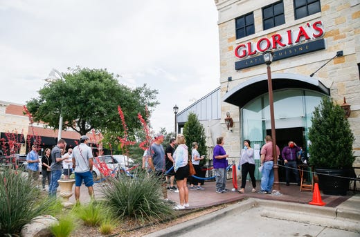 Eager to dine out, lunch goers wait outside Gloria's Latin Cuisine for a table on the patio in Colleyville, Texas on April 27, 2020.