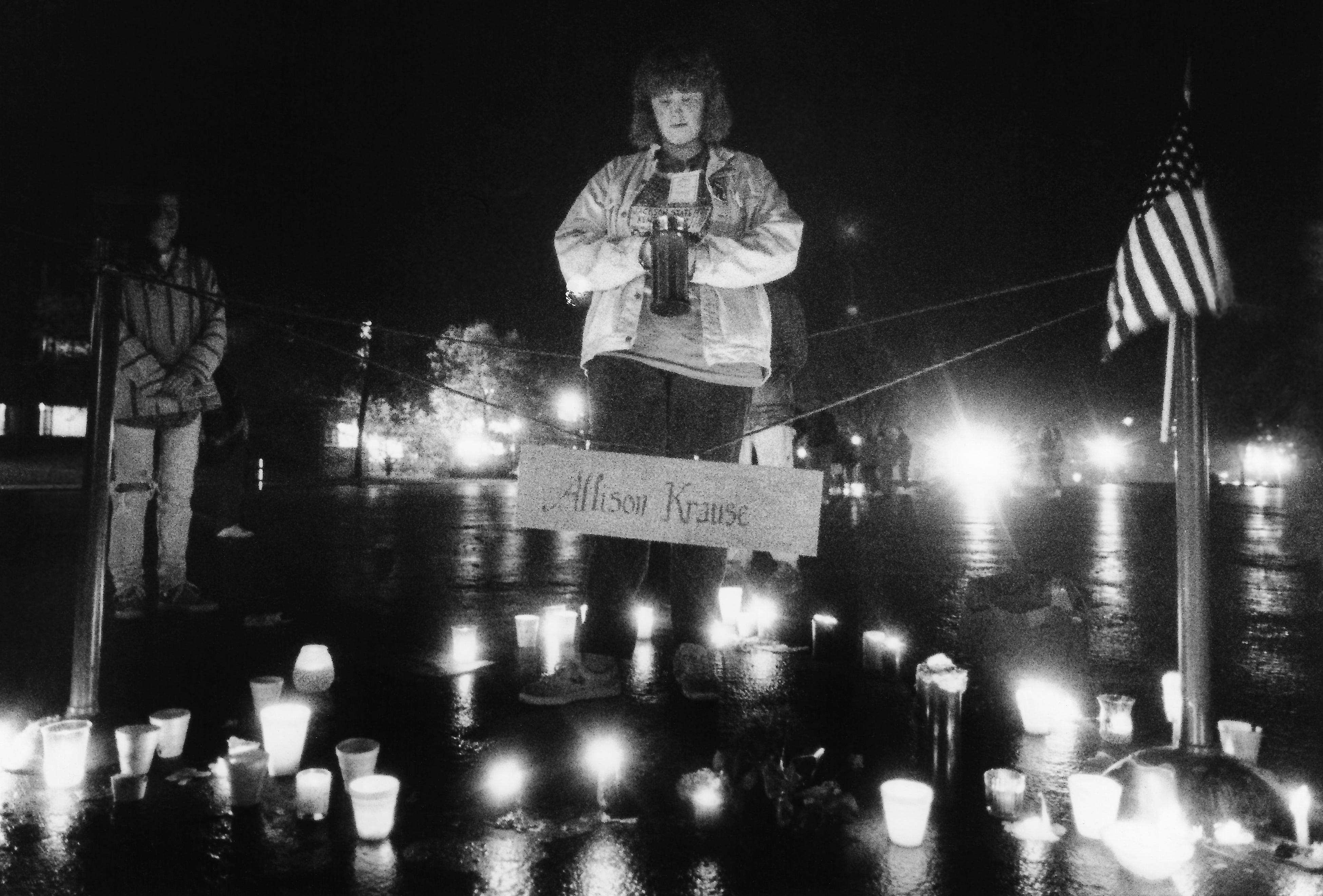 A volunteer stands vigil in the early morning hours of May 4, 1990, within a cordoned-off area commemorating the spot where Allison Krause died on May 4, 1970.