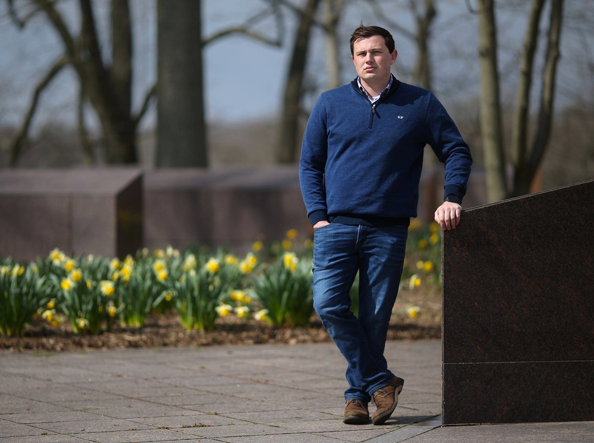 Seth Koellner, president of the Kent State College Republicans, stands in the May 4 Memorial outside Taylor Hall on Thursday, April 16, 2020, in Kent, Ohio.