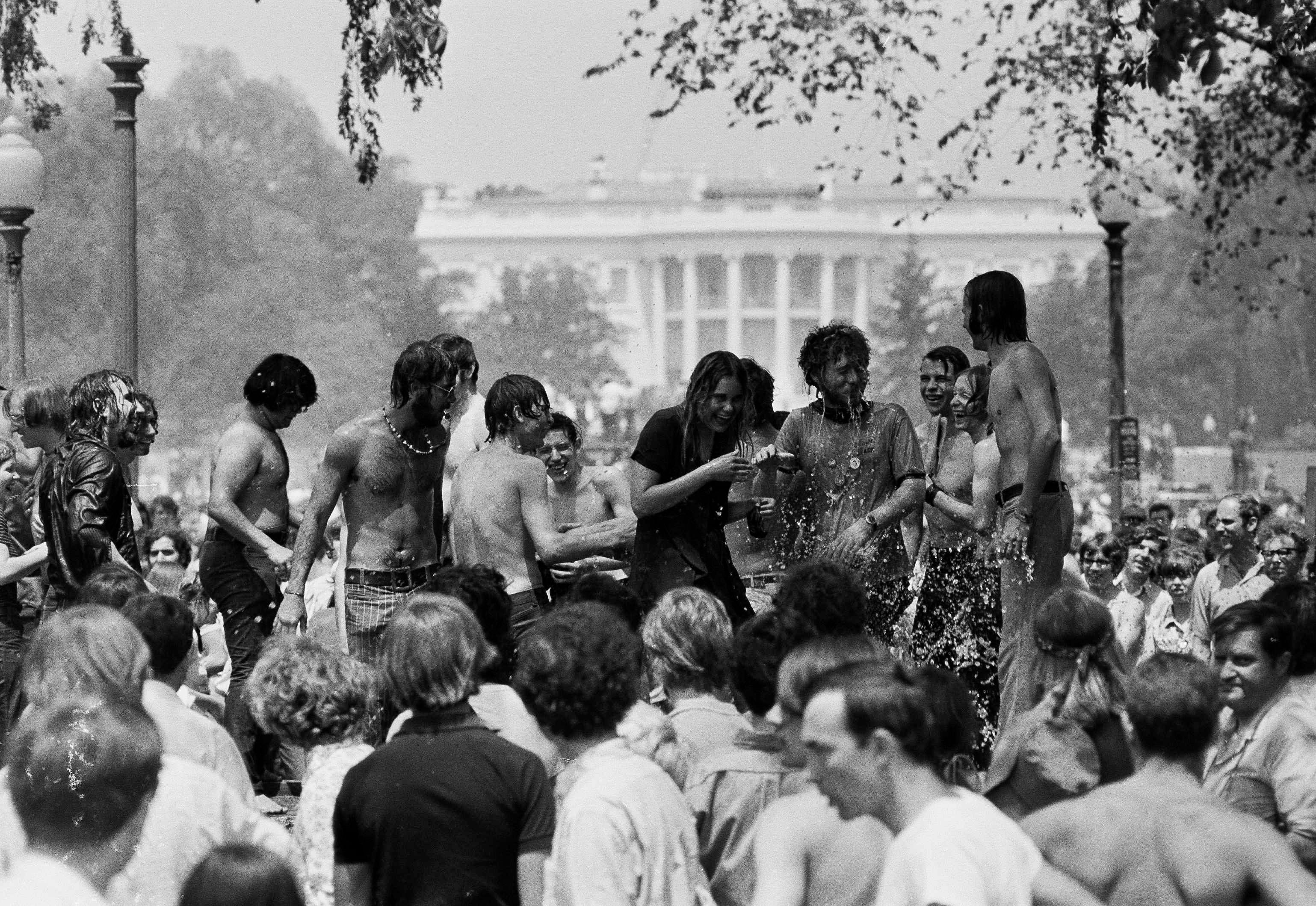 The water flies as young people clown a bit in the 88 degree weather during an anti-war demonstration on the Ellipse in Washington D.C., on May 9, 1970. The demonstrators were protesting the shootings at Kent State University and the U.S. incursion into Cambodia.