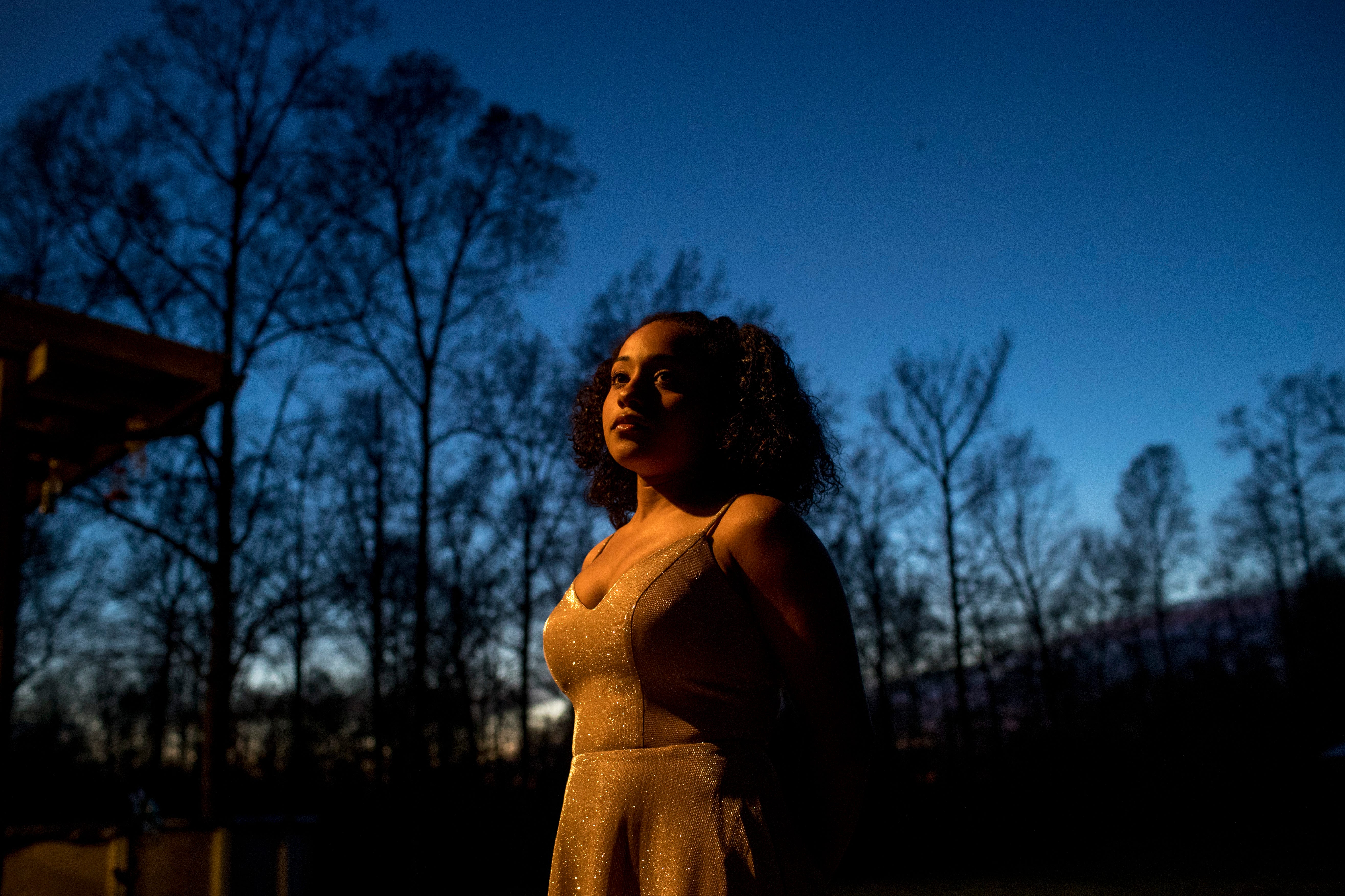 Hope Johnson, a Montgomery Central track athlete who will miss her senior season because of the coronavirus pandemic, stands in her backyard in Cunningham, Tenn., for a portrait while wearing the dress she would have worn to prom on March 29, 2020.