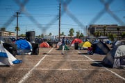 Parking lots with socially distanced camps for those experiencing homelessness in downtown Phoenix.