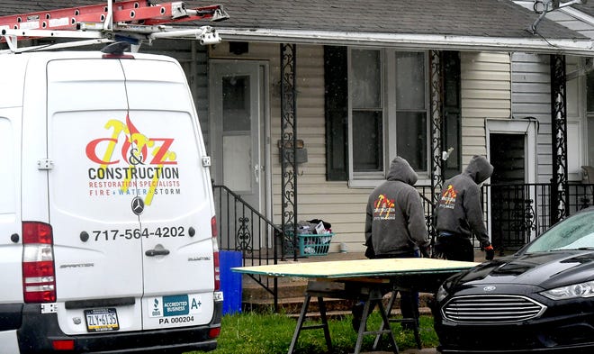 A restoration crew prepares to board windows after a fire occurred at a home on Highland Avenue Thursday, April 30, 2020. Two adults were displaced. Bill Kalina photo 