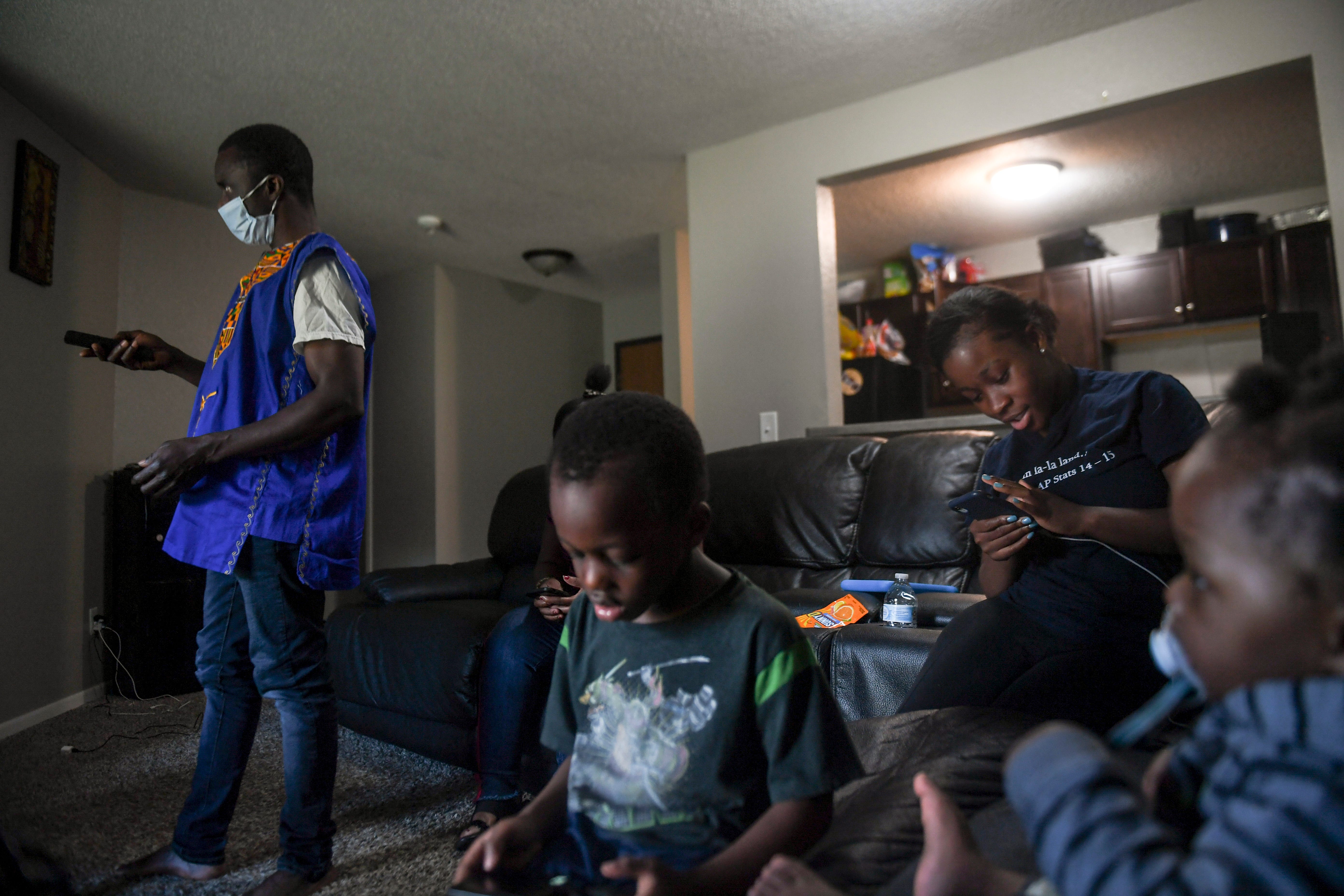 John Deranamie spends time with family on Wednesday, April 29, 2020, at his home in Sioux Falls, S.D. Deranamie would normally work more than 50 hours a week to provide for his family but has been spending time at home since Smithfield Foods shut down after becoming one of the largest hot spots for COVID-19. "I'm really enjoying it right now, even though I'm not getting overtime pay," Deranamie said. "At least my children are getting used to me; they're getting used to their dad for some time."