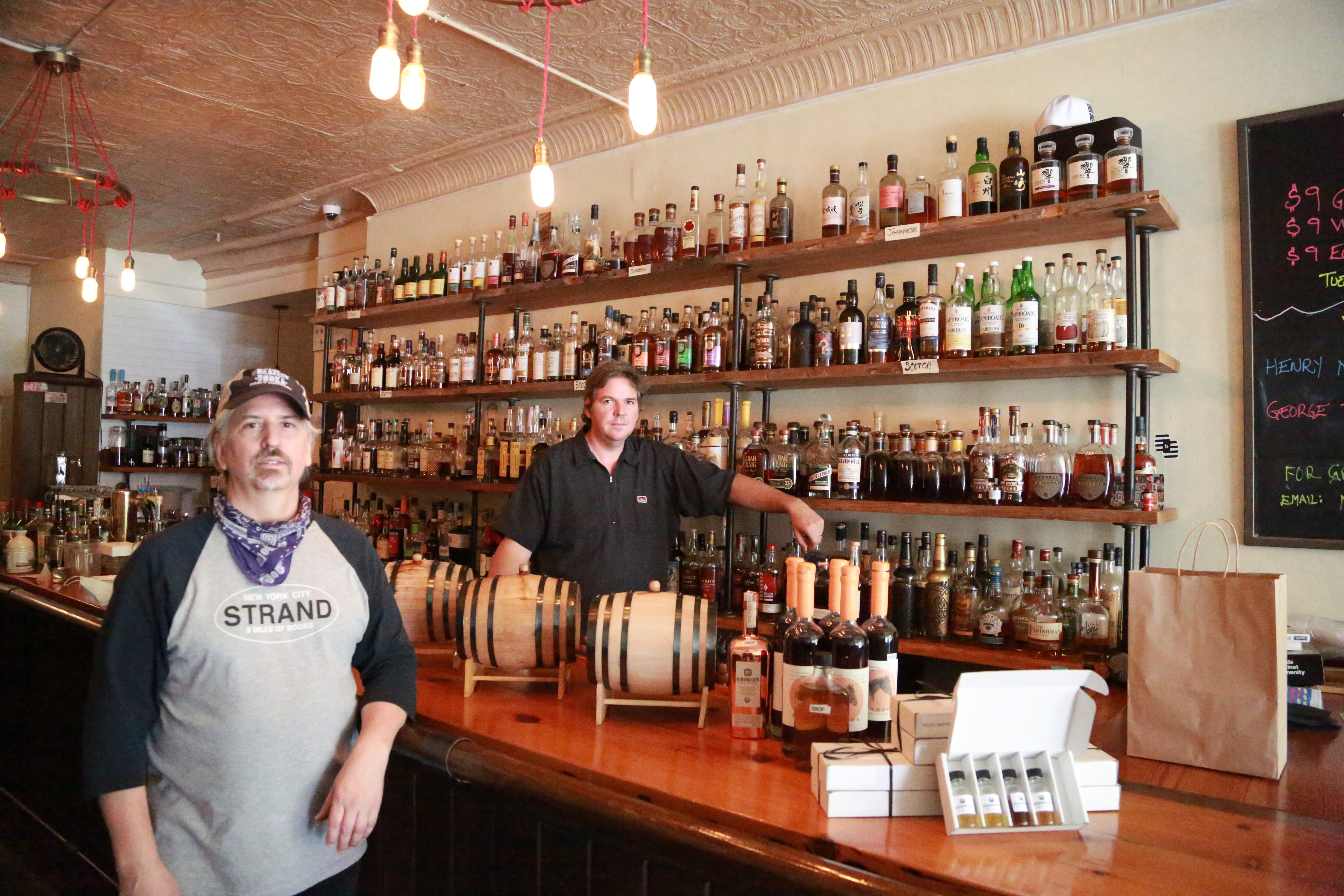 Joe Sweigart and Mike Vacheresse are co-owners of the Travel Bar in New York City's Brooklyn borough. They've been preparing batches of cocktails for customers to pick up during the limited hours the bar is open.