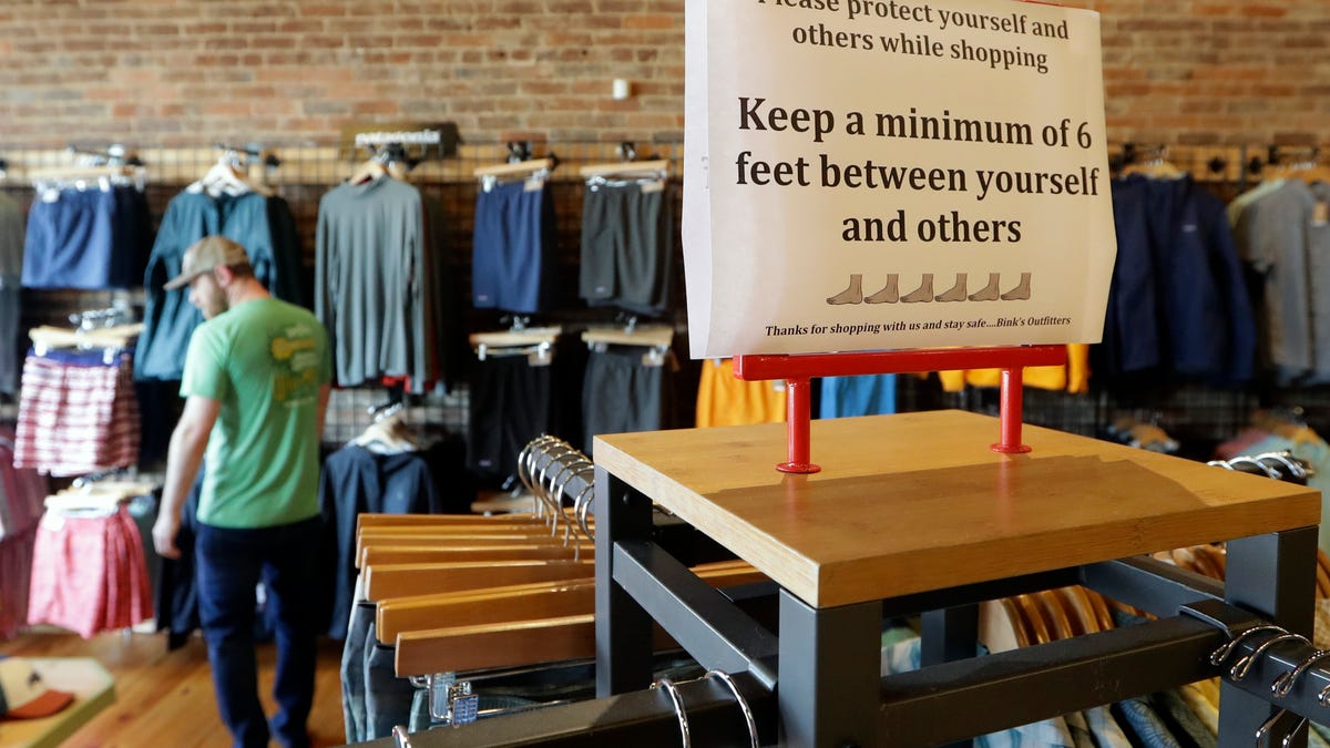 A sign reminds customers of social distancing inside the Bink's Outfitters store in Murfreesboro, Tenn. Retailers in 89 of Tennessee's 95 counties were allowed to reopen Wednesday with restrictions amid the coronavirus pandemic.