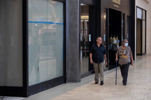 People walk thought the La Palmera Mall on Friday, May 1, 2020 the first day it has been open since the COVID-19 outbreak. 