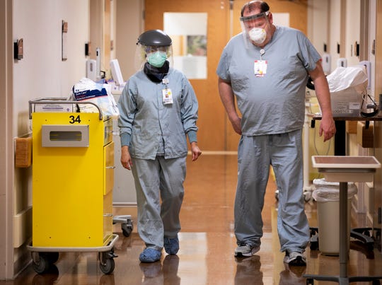 FOR SPECIAL PACKAGE: Dr. Anjum Nageed, left, and Steve Blessinger, nurse, at TriHealth Good Samaritan Hospital discuss a patient on the COVID floor after Nageed exited the room, Friday, April 24, 2020. Good Sam, as it's known, is located in Clifton, Ohio. 