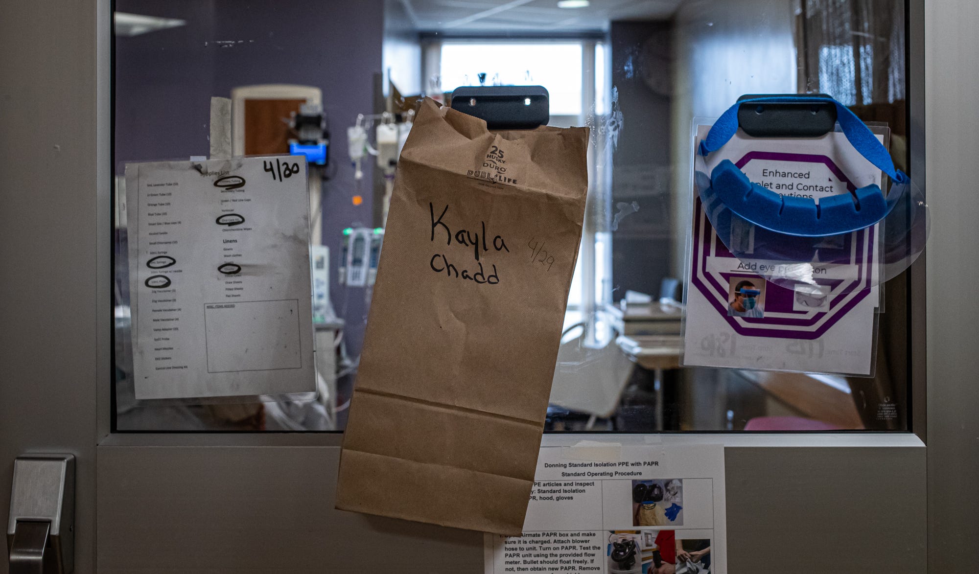 To ensure masks and other personal protective equipment aren't shared between staff members, bags with the names of nurses hang on doors inside COVID-19 areas on IU Health Methodist on Thursday, April 30, 2020.