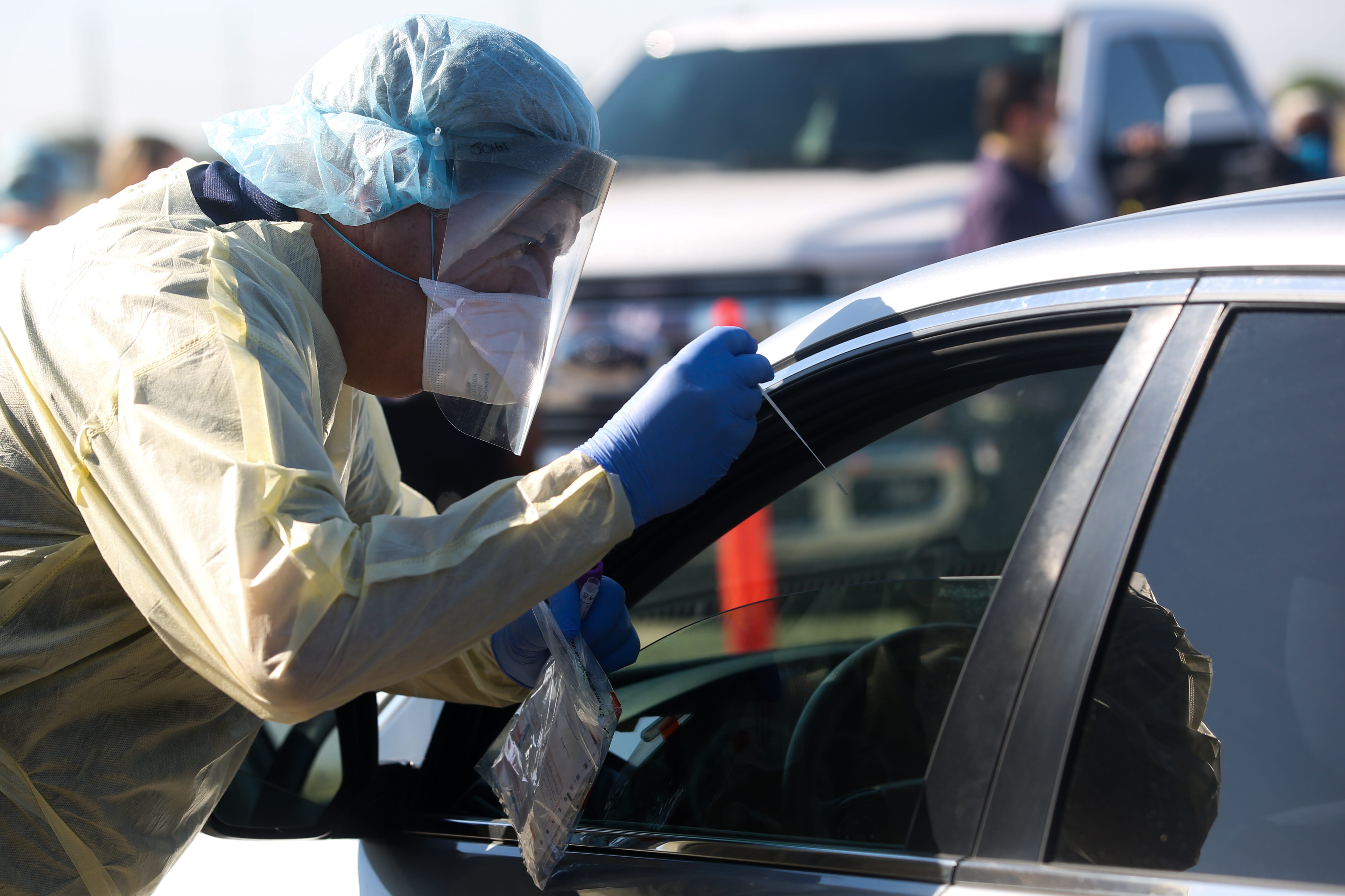 A health care worker conducts LabCorp PCR COVID-19 testing off of 
 Dillon Rd. in Coachella, Calif. on Friday, May 1, 2020. The city of Coachella, Twentynine Palms Band of Mission Indians, Borrego Health, Desert Healthcare District and Foundation and the County of Riverside partnered to open the testing location.