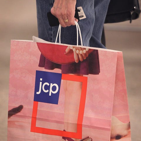 A shopper carries a bag at a J.C. Penney store in 