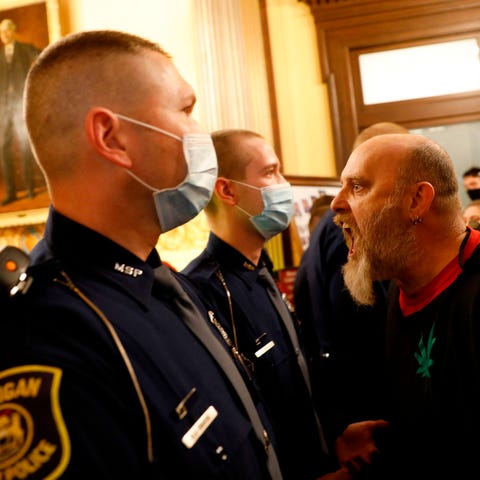 Protesters try to enter the Michigan House of Repr