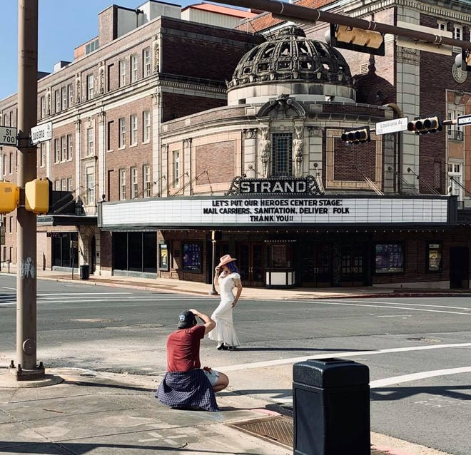 A photo session in front of the Strand Theater.