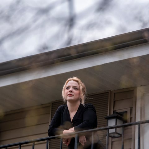 Rachel Metcalfe, 22, poses on her balcony in Naper