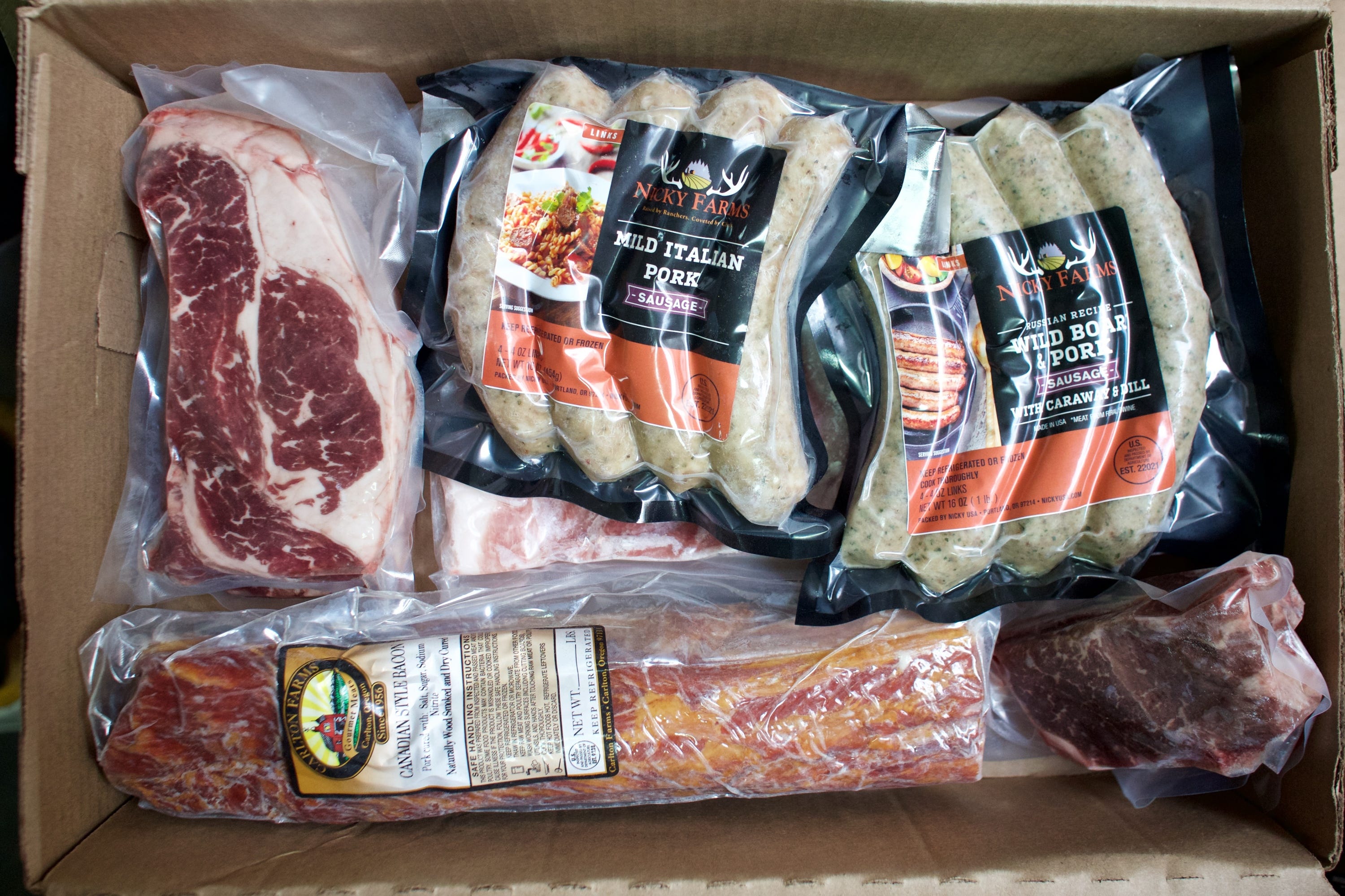 A direct to consumer "grill box" is packaged for distribution on April 28. The box includes steaks, sausages, pork chop and pork belly among other items from Nicky USA.