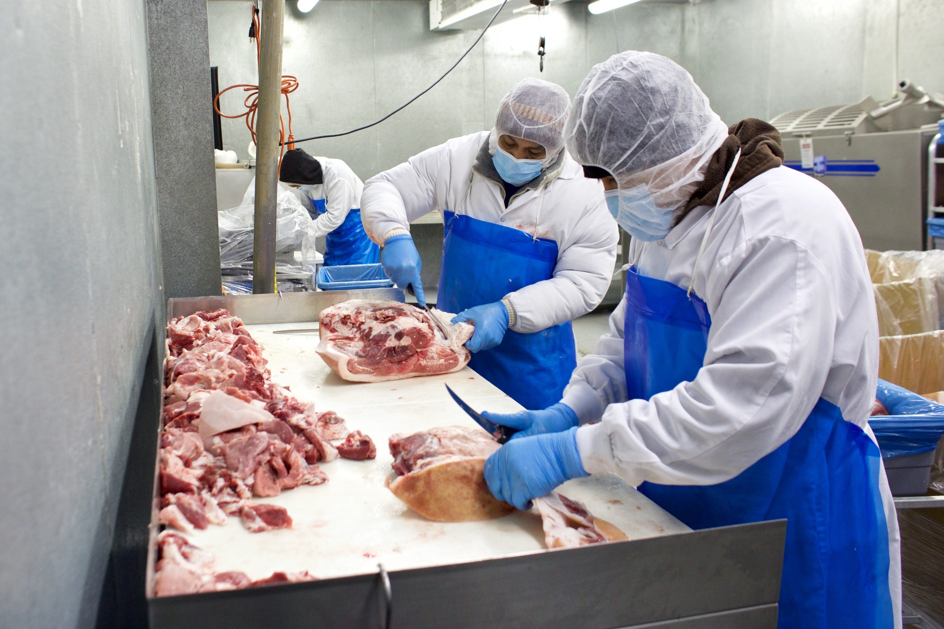 Butchers at Nicky USA cut up a pig carcass on April 28 in Portland, Ore.