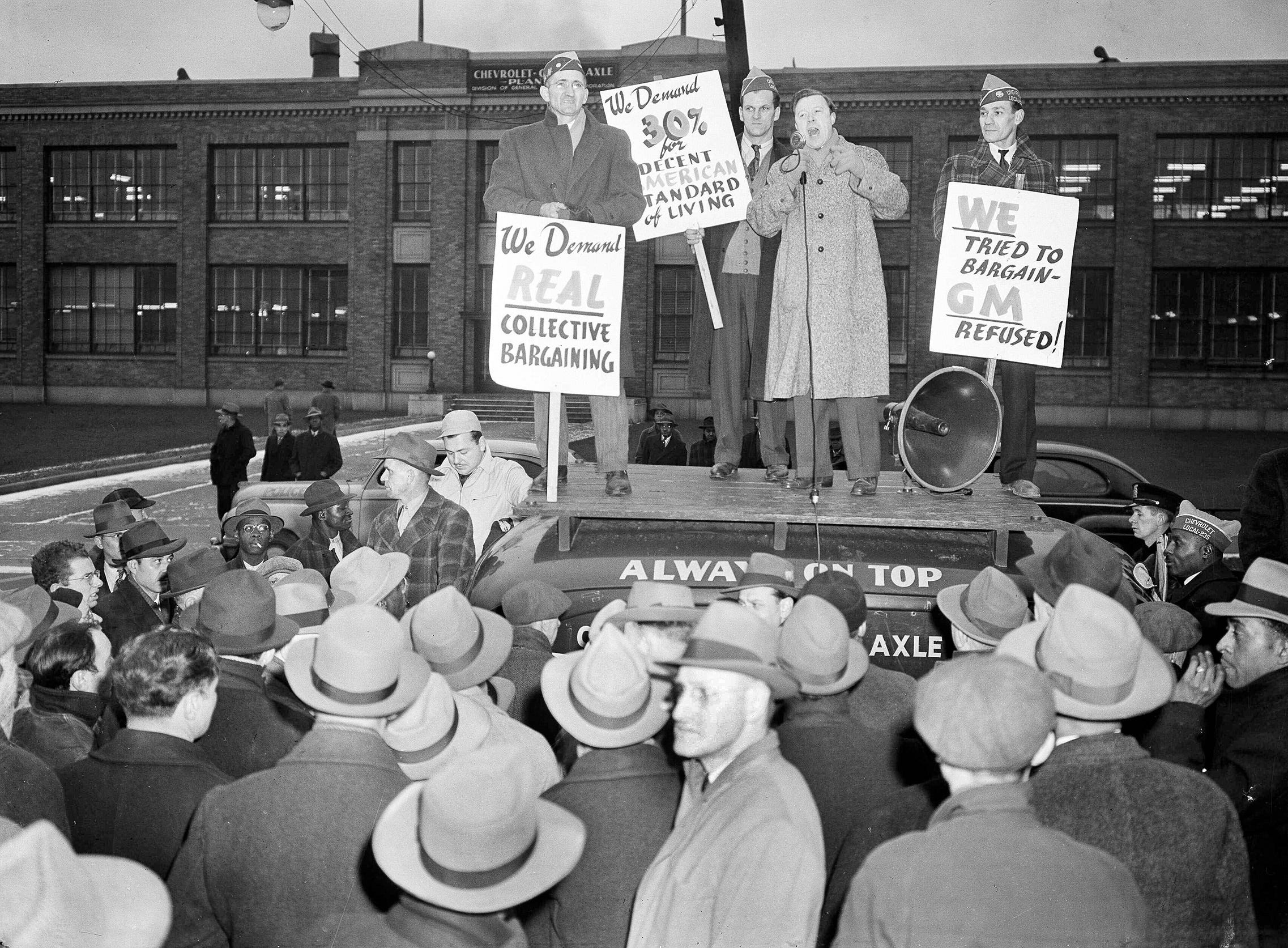 Walter Reuther, vice president of the UAW, speaks to pickets grouped around the sound truck in front of the Chevrolet Gear and Axle Plant in Detroit, Mich., Nov. 23, 1945.